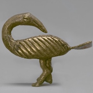 Gold sculpture of a bird with it's head turned backwards