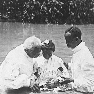 Thumbnail of two men baptizing a girl in a river