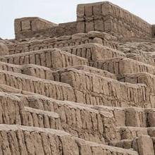 Stepped platforms made from tan-colored adobe bricks located on the plaza at Huaca Pucllana